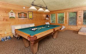 a game room with a pool table in a cabin at Simones Cottage in Gatlinburg