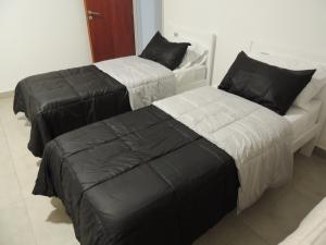 two beds sitting next to each other in a room at El Refugio de Salvador in Paraná