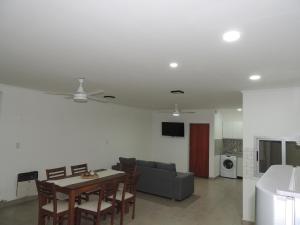 a living room with a table and a couch at El Refugio de Salvador in Paraná