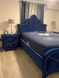 a bedroom with a blue bed and a night stand at Villa New Place in Las Vegas