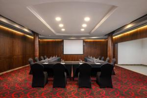 a conference room with a long table and chairs at Carlton Al Moaibed Hotel in Dammam +58 photos
