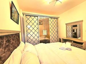 a bedroom with a white bed and a mirror at cozy cozy in Madinaty +4 photos