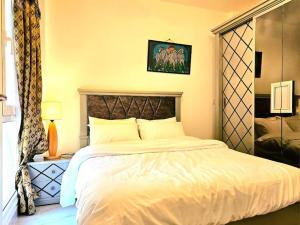 a bedroom with a large white bed in it at cozy cozy in Madinaty