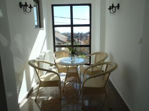 a table and chairs in a room with a window at Cloudbase Guesthouse in Sopot