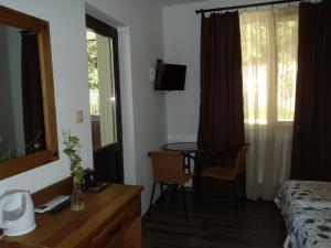a bedroom with a bed and a desk and a table at Cloudbase Guesthouse in Sopot