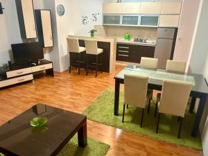 a living room with a table and chairs and a kitchen at Mario in Ohrid