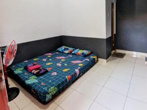 a bed with pillows on it in a room at Kosan Syariah Mas Slamet in Tasikmalaya