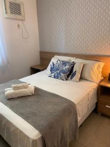 a bedroom with a bed with a white bedspread at Atlantis by Mosaico Stays in Vitória +31 photos
