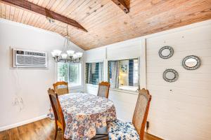 a dining room with a table and chairs at Cozy Cottage with Deck Walk to Lake of the Ozarks! in Versailles