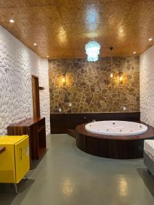 a bathroom with a large tub in the middle of the room at Kanto do Chico in Icaraí +55 photos