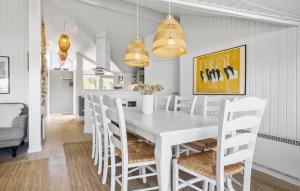 a white dining room with a white table and chairs at Holiday Home Ballesvej in Sillerslev