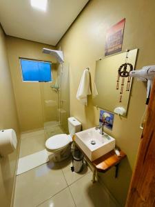 a bathroom with a toilet and a sink at El Caminito in São Borja +84 photos