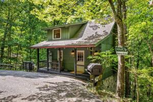 una casa verde en medio del bosque en Relaxing Escape, en Pigeon Forge