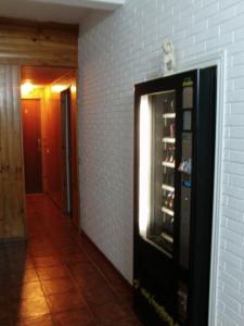a vending machine is next to a brick wall at Hostal La Torre in Santander