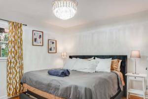 a bedroom with a bed with a blue bag on it at Charming 4-Bed Home with Modern Touches & Porch in Louisville