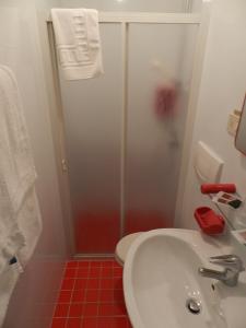 a bathroom with a toilet and a sink and a shower at Locanda Trattoria Caffè Cavour in Cittadella