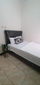 a bed with two pillows on it in a room at Homestay Syariah Studio A50 Panjalu in Panjalu