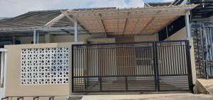 a gate in front of a house with awning at Homestay Syariah Studio A50 Panjalu in Panjalu