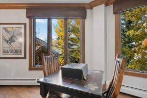 a dining room with a table with a television on it at McCoy Peak 204 by East West Hospitality in Beaver Creek