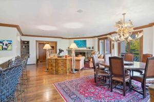 a dining room and living room with a table and chairs at McCoy Peak 204 by East West Hospitality in Beaver Creek