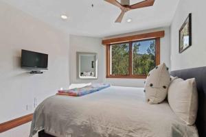 a bedroom with a large bed with a pillow on it at McCoy Peak 305 by East West Hospitality in Beaver Creek