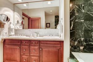 a bathroom with two sinks and a large mirror at McCoy Peak 202 by East West Hospitality in Beaver Creek +12 photos