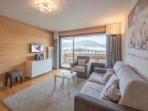 a living room with a couch and a chair at Appartement familial au centre avec balcon et WiFi - FR-1-645-75 in LʼHuez