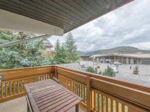a balcony with a table and a view of a street at Appartement familial au centre avec balcon et WiFi - FR-1-645-75 in LʼHuez