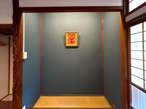 a room with a blue wall with a painting on it at tot-an 14mins from Toyama station #HH7 in Toyama Station +12 photos
