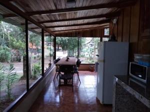 a kitchen with a table and a refrigerator on a porch at Roca Verde - Monteverde Cloud Forest Lodging in Monteverde Costa Rica +28 photos