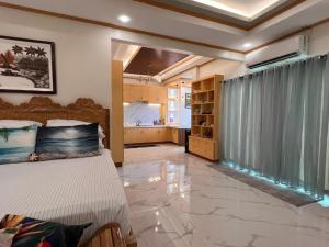 a large bedroom with a bed and a kitchen at Spacious Seaview Studio in Lila, Bohol in Lila