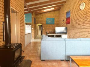 a living room with a couch and a stove at Puggle Palace, 21A Bower Street in Jurien Bay
