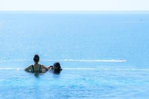 a woman and a child in the water at Awaken Da Nang Hotel in Danang