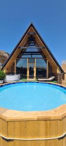 a large swimming pool in front of a building at Baku Garden Aframe - Bungalov in Baku