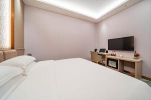 Voodi või voodid majutusasutuse 玺程国际酒店广州天河智慧城店 toas