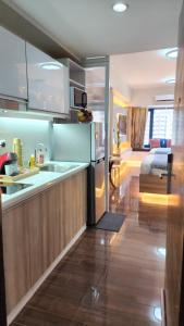 a kitchen and a living room with a bed at Makati Air Luxury Package - Laugh Sleep Brunch Surf 300 mbps Fast in Manila