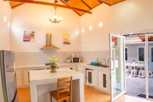 a kitchen with a table and a counter top at ROMANTIC Pool Villa in Pattaya South