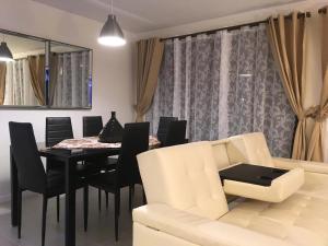 a dining room with a table and chairs and a couch at Casa Tipo Town House in Pucón