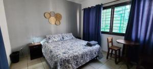 a bedroom with a bed and a table and a window at Travelero Hostel & Tours in Santa Cruz de la Sierra +14 photos