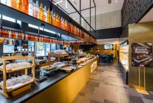 a restaurant with a counter with food on it at CitiGo Hotel Shanghai JingAn in Shanghai
