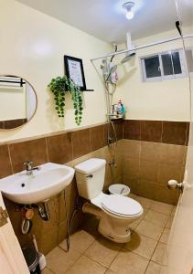 a bathroom with a toilet and a sink at The Boho Bungalow in Sasabayou