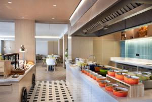 a large kitchen with lots of food on a counter at Home2 Suites By Hilton Wuxi Huishan in Wuxi