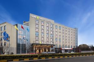 a building with a sign on the front of it at Home2 Suites By Hilton Wuxi Huishan in Wuxi