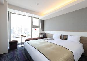 Voodi või voodid majutusasutuse Urban Hotel Kyoto Gojo Premium toas