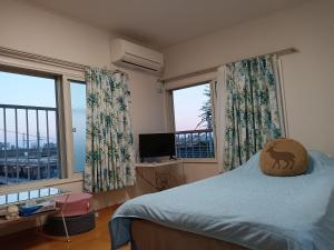 Ένα ή περισσότερα κρεβάτια σε δωμάτιο στο Tokyo downtown牡丹莊