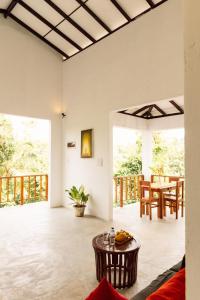 an open living room with a table and chairs at Hiriketiya Ladina Homestay in Dickwella