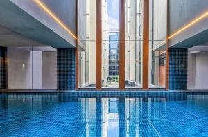 a swimming pool in a building with windows at Little Midnight 2 in Canberra
