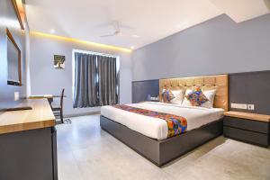 a bedroom with a bed and a desk in a room at FabHotel Prime The Water View Residency - Nr Bisarjan Ghat in Kolkata +36 photos