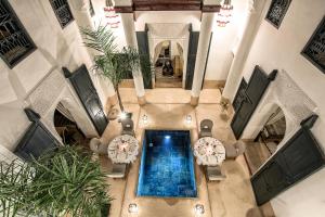 an overhead view of a swimming pool in a building at Dar Assiya in Marrakesh