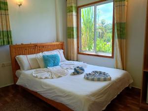 Postel nebo postele na pokoji v ubytování Olhumathi View Inn